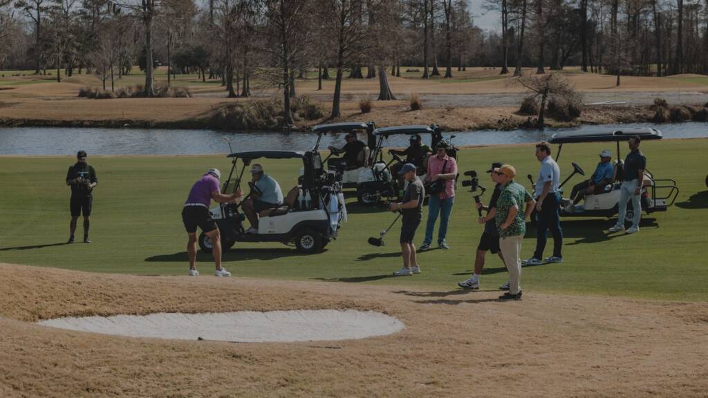 Celebrity golfer parking cart near tee box