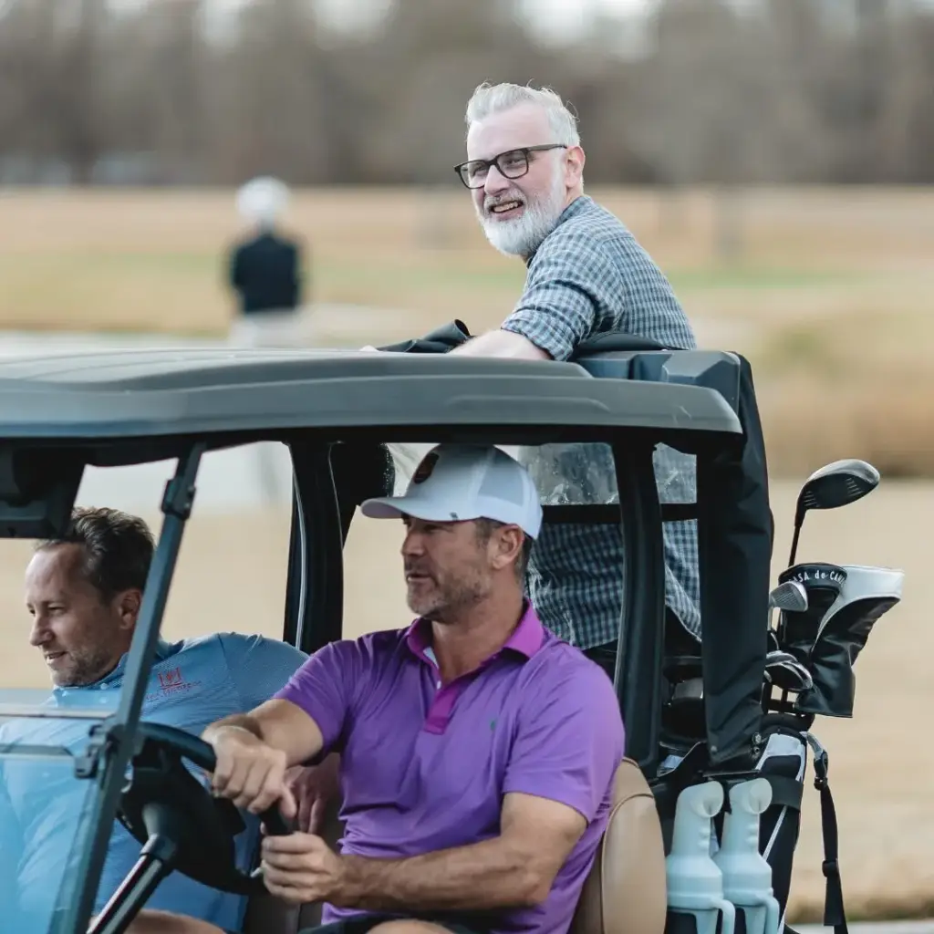 celebrity players take a ride on the golf cart