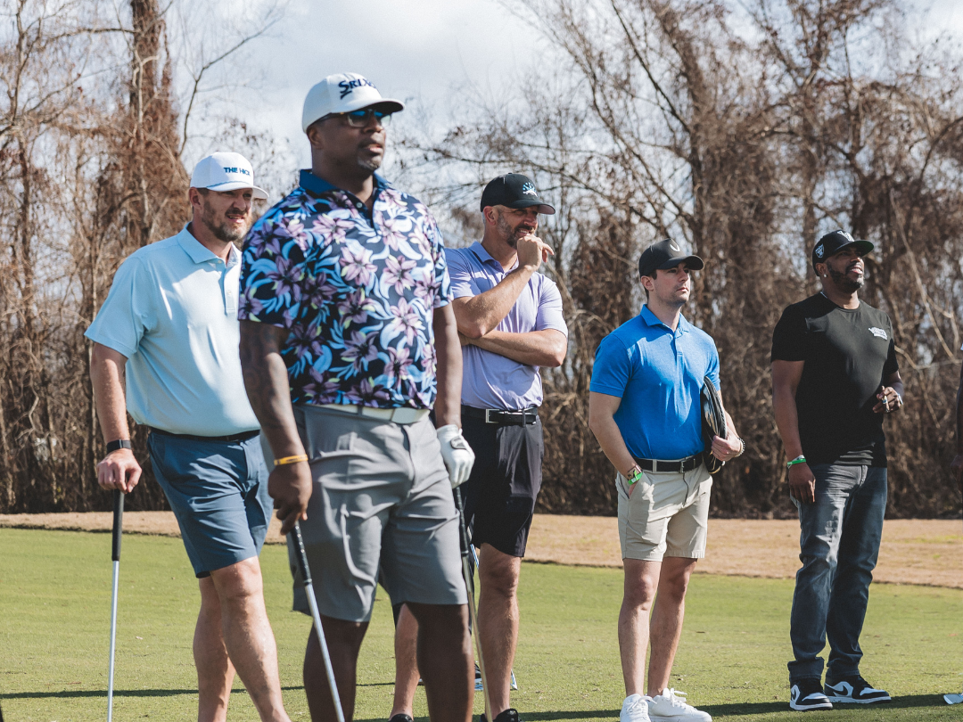 Golfer smiling at audience after sinking a long birdie putt