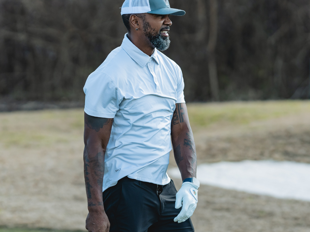 Golfer watching ball trajectory after a long iron shot