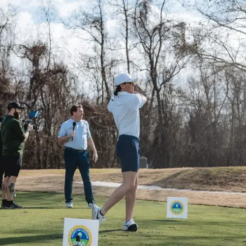 Golfer hitting out of a deep