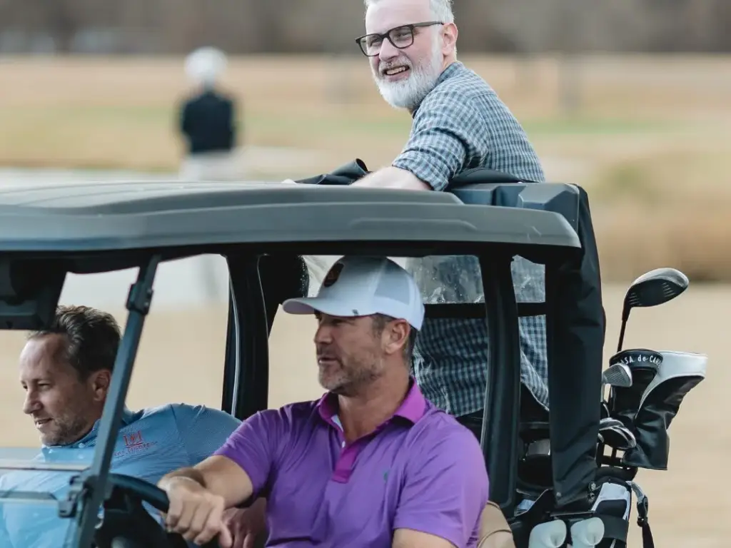 celebrity players take a ride on the golf cart